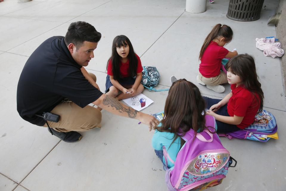Armando Avelino, a program specialist, works with kids at ICAN, an after-school program in Chandler on Nov. 20, 2018.