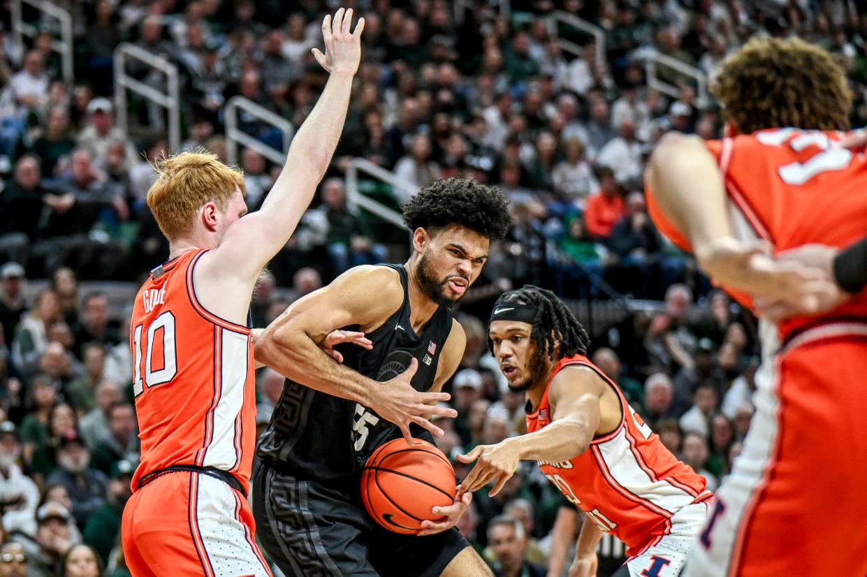 Michigan State's Malik Hall, center, is fouled while moving between Illinois' Luke Goode, left, and Ty Rodgers during the first half on Saturday, Feb. 10, 2024, at the Breslin Center in East Lansing.