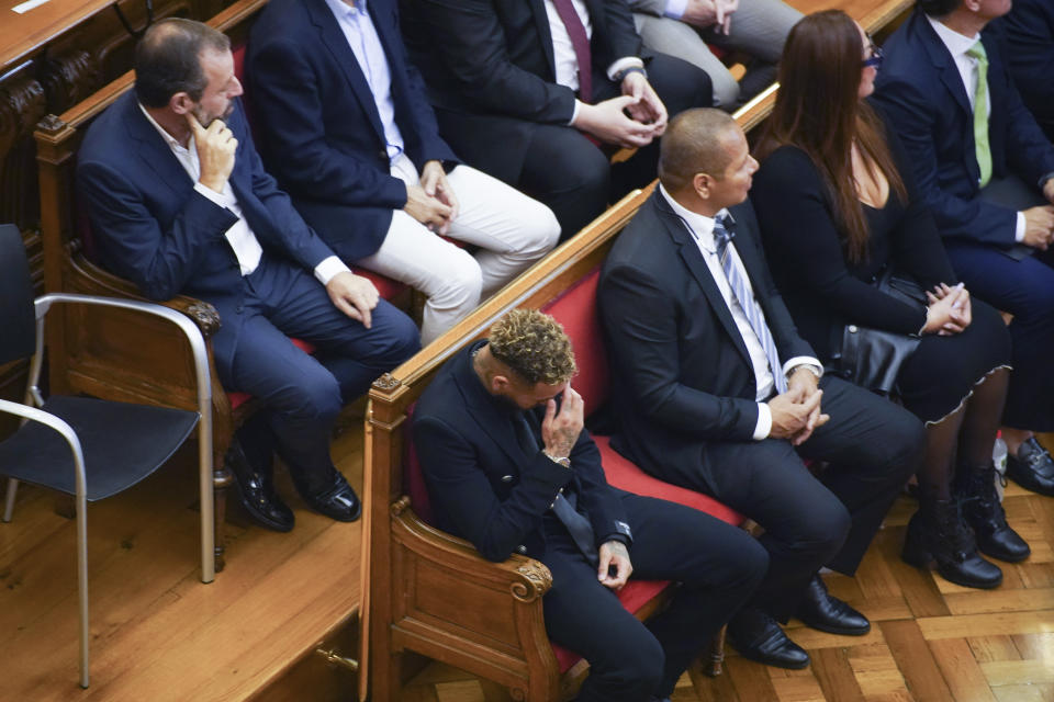 Former FC Barcelona player Neymar who now plays for Paris Saint-Germain, centre, sits in court in Barcelona, Spain, Monday Oct. 17, 2022. Neymar is in court in Barcelona to face a trial over alleged irregularities involving his transfer to Barcelona in 2013. Neymar's parents, former Barcelona president Sandro Rosell and representatives for both the Spanish club and Brazilian team Santos are also in court after a complaint brought by Brazilian investment group DIS regarding the amount of the player's transfer. All defendants have denied wrongdoing. (AP Photo/Joan Mateu Parra)