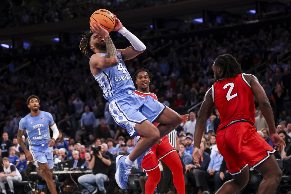 North Carolina guard R.J. Davis (4) shoots during the second half of an NCAA college basketball game against Ohio State in the CBS Sports Classic, Saturday, Dec. 17, 2022, in New York. The Tar Heels won 89-84 in overtime. (AP Photo/Julia Nikhinson)