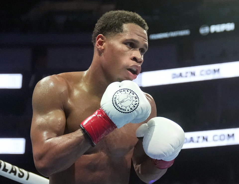 FILE - Devin Haney fights Regis Prograis during a WBC super lightweight title boxing fight in San Francisco, Dec. 9, 2023. The fighters seemed just as surprised as fight fans when it was announced that Haney and Ryan Garcia, two Californians, would have their April 20, 2024, title fight in New York. But Oscar De La Hoya, Garcia’s promoter, says bringing the event to Brooklyn is common sense. (AP Photo/Jeff Chiu, File)