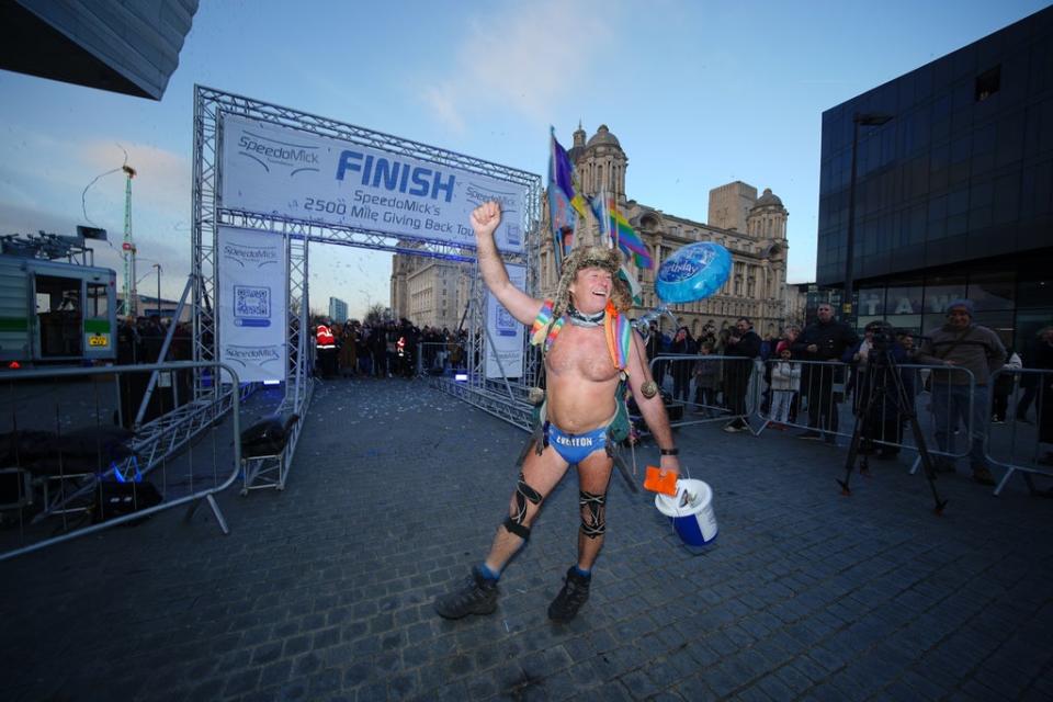 Mick Cullen, otherwise known as Speedo Mick, arrives in Liverpool, where he finished a 2,500-mile, five-month trek across the UK and Ireland (PA) (PA Wire)