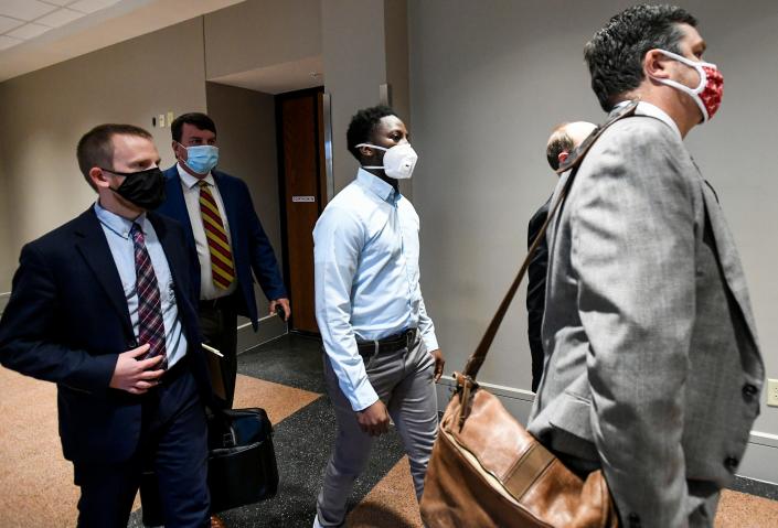 Tory Johnson, center, a suspect in the Bama Lanes shooting, arrives with lawyers for his bail hearing at the Montgomery County Courthouse in Montgomery, Ala., on Thursday January 13, 2022. 