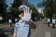 Chinese police officers block the road leading to the Philippines embassy in Beijing after an international court ruled against China in a Philippine challenge over Beijing-occupied territory in the South China Sea