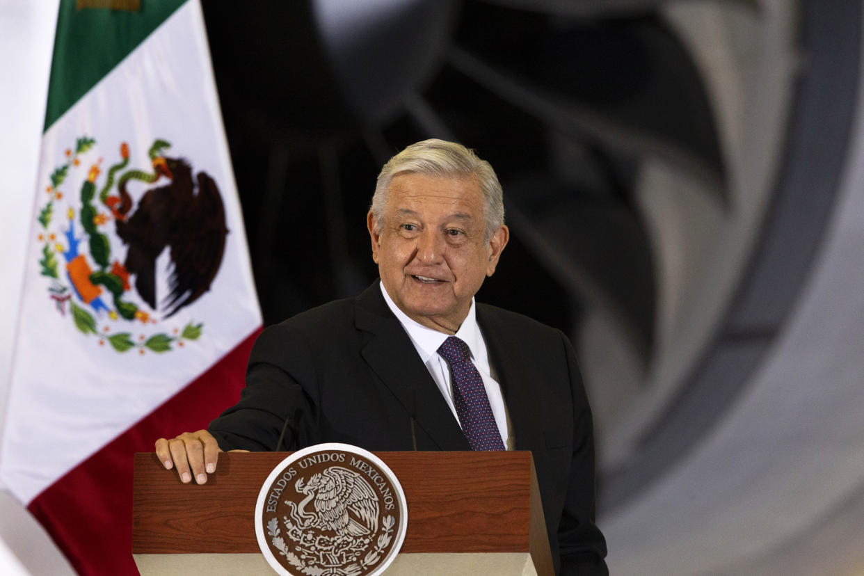 Mexican President Andres Manuel Lopez Obrador gives his daily, morning press conference in front of the former presidential plane at Benito Juarez International Airport in Mexico City, Monday, July 27, 2020. The president, who only flies commercial as one measure in his austerity government, has been trying to sell the plane since he took office. (AP Photo/Marco Ugarte)