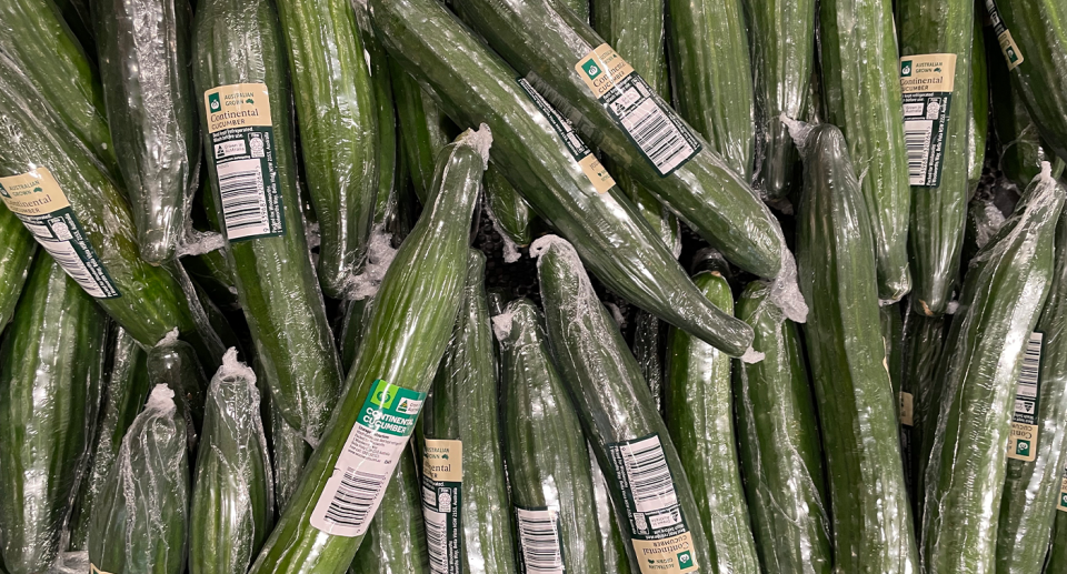 Cucumbers wrapped in plastic at Woolworths.