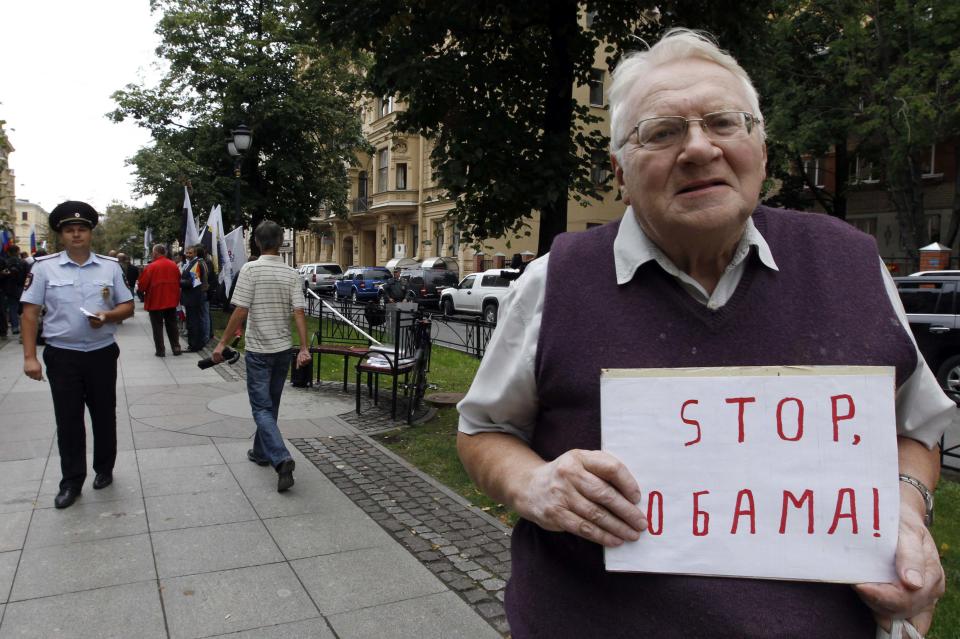 A participant holds a placard during a protest against possible U.S. military action in Syria near the U.S. consulate in St. Petersburg