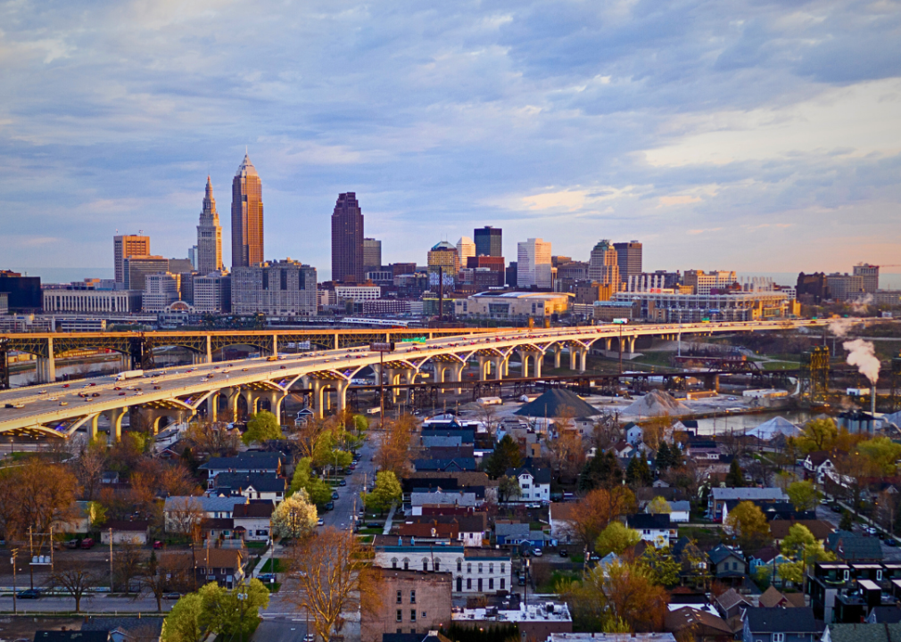 A skyline of the city with tall buildings with highways in the foreground.  