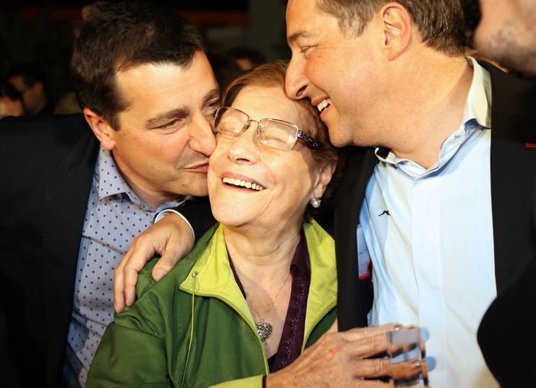 Joan Roca (R) and Josep Roca (L) kiss their mother Montserrat Fontane (C) at the restaurant in Girona on April 30, 2013. Three brothers in Spain's northeastern Catalonia region who snatched the title for the world's best restaurant, the Celler de Can Roca, humbly trace their inspiration to their mum's cooking