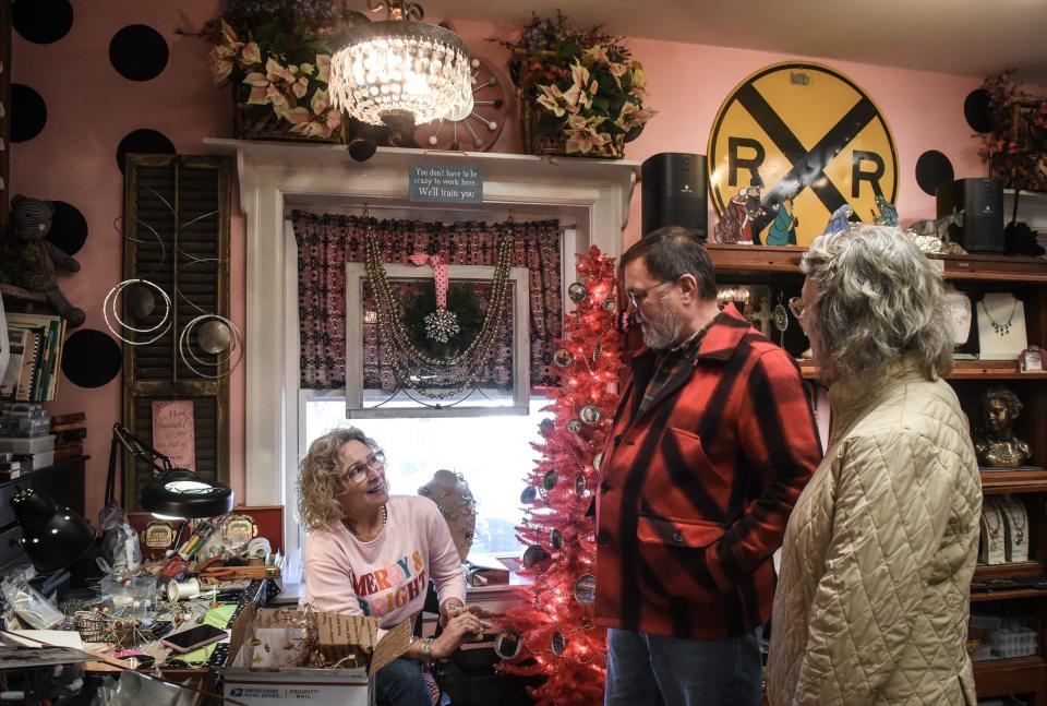 "We want our local businesses to thrive," Cathy Hunter, right of Rives Junction says as she and husband Tony shop at Margaret Ross's custom jewelry shop inside Kean's Store Co. in downtown Mason Wednesday, Dec. 7, 2022. The old-fashioned variety store has been open for 94 years.