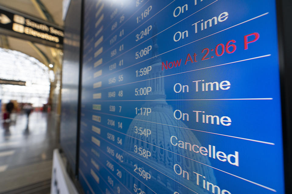 A flight shows cancelled on the departures board at Ronald Reagan Washington National Airport, Wednesday, Dec. 29, 2021, in Arlington, Va. Winter weather and crew members infected with COVID-19 have forced airlines to spike thousands of U.S. flights over the past week, complicating travel plans for many people during the busy holiday season. It’s not clear when travel will return to normal, but airlines say a recent move by U.S. public health officials should help get workers back sooner. (AP Photo/Alex Brandon)