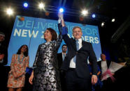 New Zealand Prime Minister Bill English and his wife Mary react on stage alongside family members during an election night event in Auckland, New Zealand, September 23, 2017. REUTERS/Nigel Marple