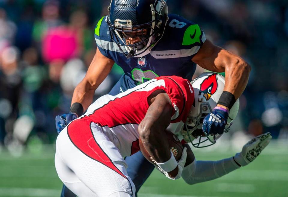 Seattle Seahawks cornerback Coby Bryant (8) tackles Arizona Cardinals wide receiver Marquise Brown (2) in the first quarter of an NFL game on Sunday, Oct. 16, 2022, at Lumen Field in Seattle.