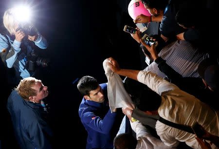 Serbia's Novak Djokovic signs autographs after winning his final match against Britain's Andy Murray at the Australian Open tennis tournament at Melbourne Park, Australia, January 31, 2016. REUTERS/Jason Reed