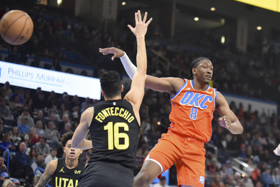 Oklahoma City Thunder forward Jalen Williams (8) passes the ball past Utah Jazz forward Simone Fontecchio (16) in the first half of an NBA basketball game, Monday, Dec. 11, 2023, in Oklahoma City. (AP Photo/Kyle Phillips)