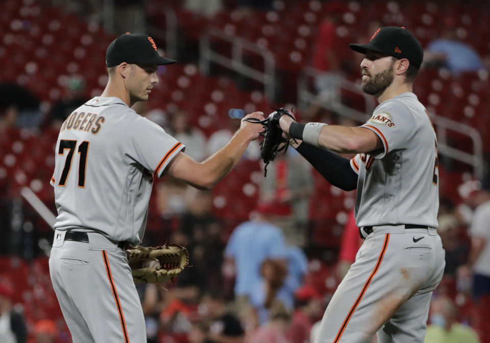San Francisco Giants relief pitcher Tyler Rogers (71) celebrates with teammate Curt Casali after finishing off the St. Louis Cardinals in the ninth inning of a baseball game, Friday, July 16, 2021, in St. Louis. (AP Photo/Tom Gannam)