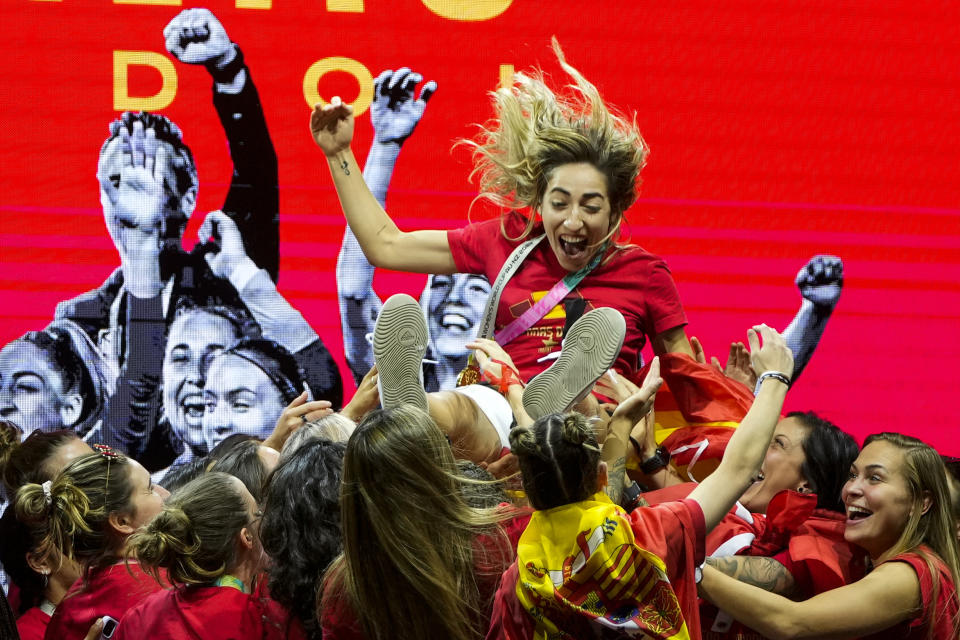 Spain women's national football team's players lift Spain's Olga Carmona as they celebrate on stage their 2023 World Cup victory in Madrid, Spain, Monday, Aug. 21, 2023. Spain beat England in Sydney Sunday to win the Women's World Cup soccer final. (AP Photo/Manu Fernandez)