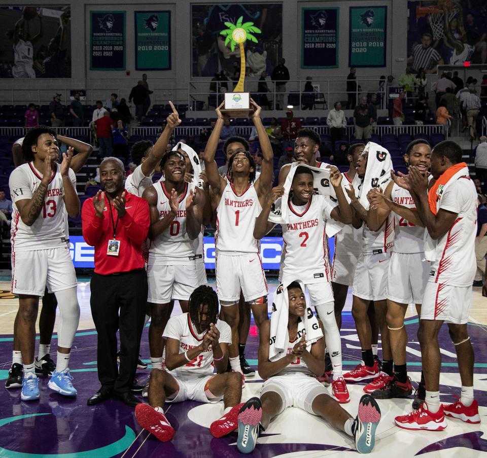 Imhotep Charter celebrates their win over Columbus in the City of Palms Classic Championship game on Wednesday, Dec. 21, 2022, at Suncoast Credit Union Arena in Fort Myers.