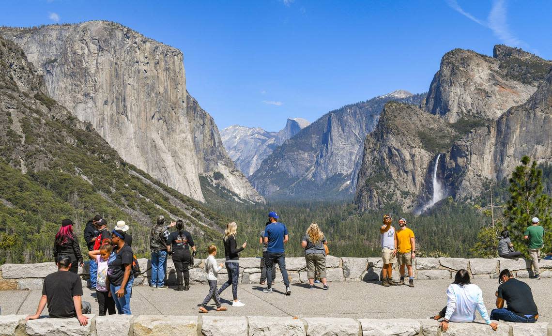 Visitors take in the splendor of Yosemite Valley at Tunnel View in Yosemite National Park on a spring day in 2021.