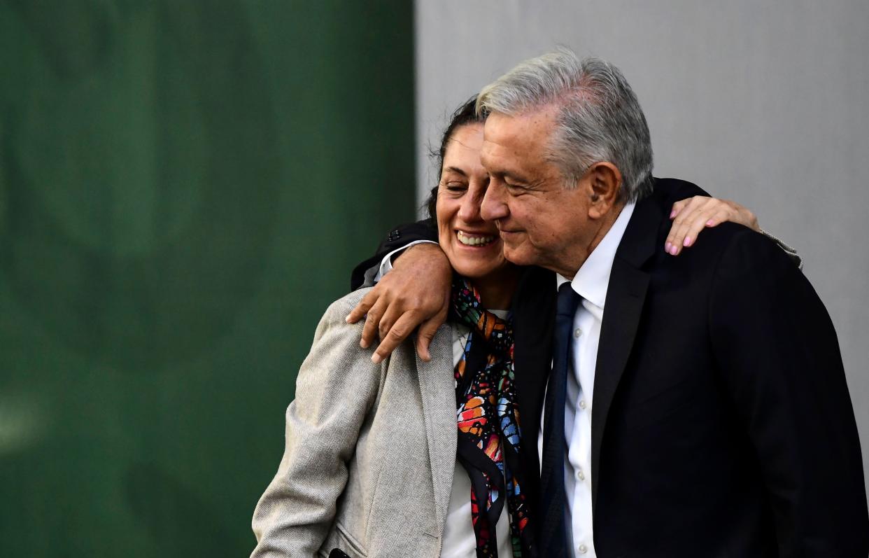 Mexican President Andres Manuel Lopez Obrador (R) hugs Mexico City's Mayor Claudia Sheinbaum after presenting his government report, at the Zocalo square in Mexico City, on July 1, 2019. - Lopez Obrador celebrates the first anniversary of his election victory with a report that ensures that economy rates will be very positive despite disappointing indicators. (Photo by RONALDO SCHEMIDT / AFP)        (Photo credit should read RONALDO SCHEMIDT/AFP via Getty Images)