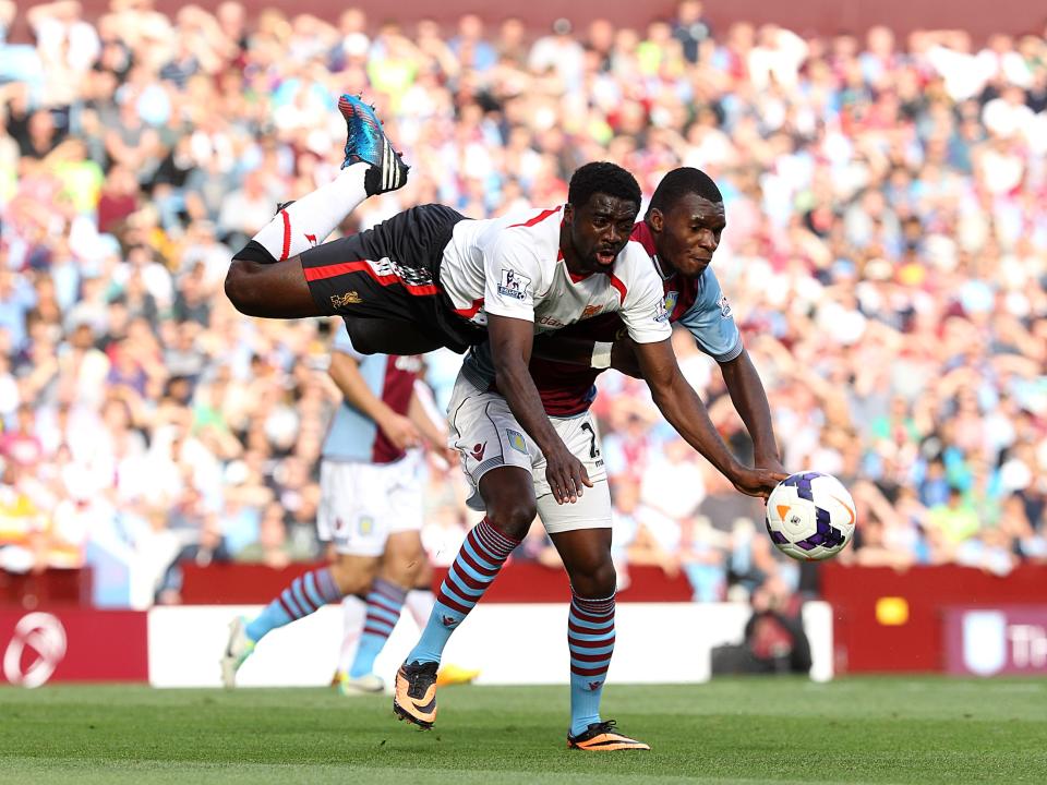 Liverpool's Kolo Toure (left) and Aston Villa's Christian Benteke (right) battle for the ball