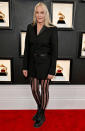 <p>Actress (and wife of Neil Young) Daryl Hannah adds a little rock-n-roll to her tuxedo dress with striped tights and lug sole boots.</p>