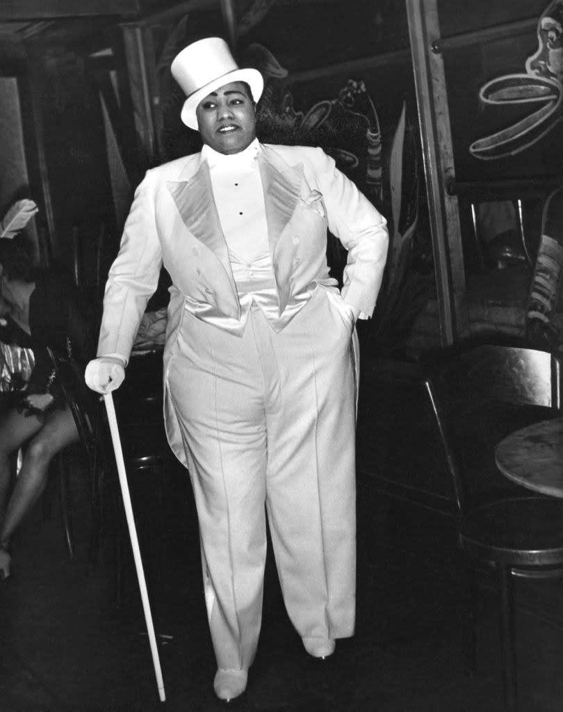 Gladys Bentley standing in men's clothing backstage