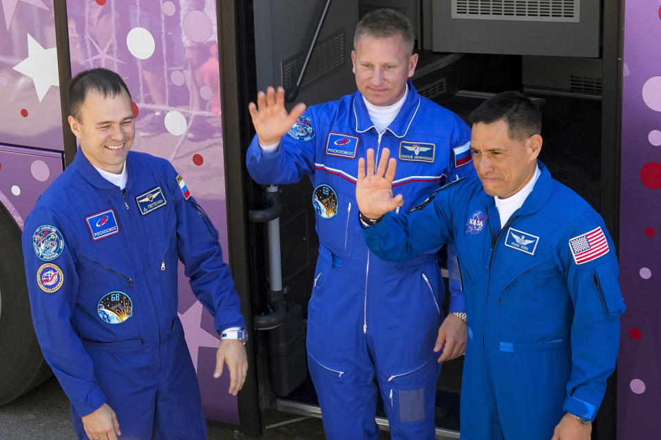 FILE - NASA astronaut Frank Rubio, right, Roscosmos cosmonauts Sergey Prokopyev, center, and Dmitri Petelin, members of the main crew heading to the International Space Station (ISS), wave to their relatives and friends in front of a bus prior the launch of Soyuz-2.1 rocket at the Russian leased Baikonur cosmodrome, Kazakhstan, on Sept. 21, 2022. NASA and Russia's space agency canceled a spacewalk by the two Russian cosmonauts, Prokopyev and Petelin, just as they were preparing to exit the International Space Station late Wednesday, Dec. 14 because of an apparent coolant leak from an attached space capsule. (AP Photo/Dmitri Lovetsky, File)