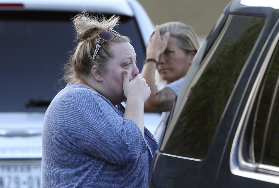 Marilee White, left, with sister Jaime White react outside First Baptist Church in New Braunfels, Texas, after several people who attended the church died in a two vehicle collision Wednesday, March 29, 2017. It was not immediately clear what caused the deadly crash involving a van carrying church members and a pickup truck on U.S. 83 outside Garner State Park in northern Uvalde County, Texas. (Tom Reel/The San Antonio Express-News via AP)