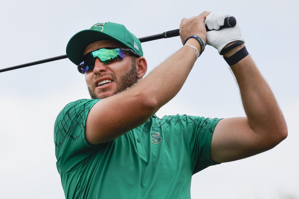 Dean Burmester of the Stinger golf club plays his shot from the eighth tee during the final round of LIV Golf Miami golf tournament at Trump National Doral.