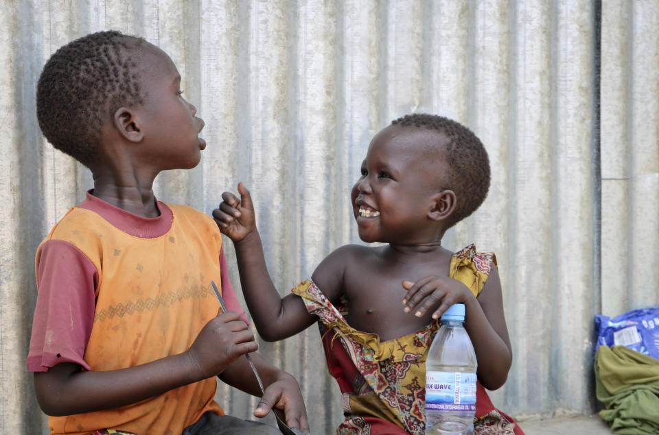 In this photo taken Tuesday, April 2, 2019, children play outside a community center at an internally displaced person's camp, during a visit by human rights activist Mia Farrow, in the capital Juba, South Sudan. Human rights activist Mia Farrow spoke to The Associated Press as she visited South Sudan again in her new role as envoy for the International Rescue Committee, helping the aid group to promote a global initiative to change the way humanitarian organizations approach malnutrition. (AP Photo/Sam Mednick)