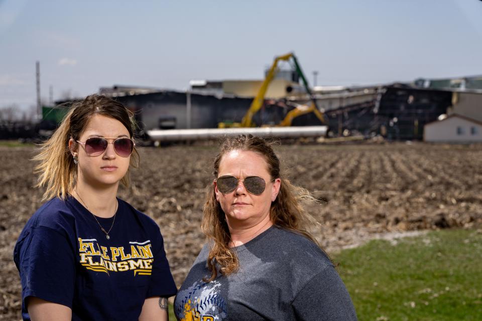 Former C6-Zero employees Lani Mumby and Joni Parizek, stand for a photo outside of the plant in Marengo Monday, April 10, 2023. 