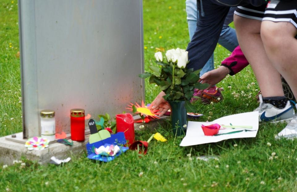 A pupil of the Kaulbach secondary school places a sticker in front of the school in Bad Arolsen (REUTERS)