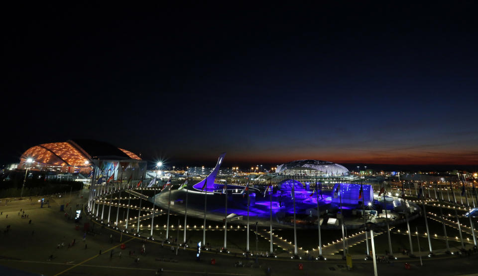 The sun sets over the Olympic Park before the opening ceremony of the 2014 Winter Olympics in Sochi, Russia, Friday, Feb. 7, 2014. (AP Photo/Julio Cortez)