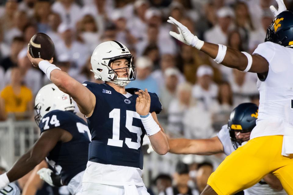 Penn State quarterback Drew Allar gets a pass off with West Virginia pressure closing in on him during the season opener at Beaver Stadium September 2, 2023, in State College.