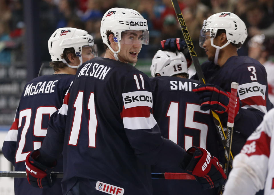 USA players celebrate their goal during the Group B preliminary round match between Switzerland and USA at the Ice Hockey World Championship in Minsk, Belarus, Saturday, May 10, 2014. (AP Photo/Darko Bandic)