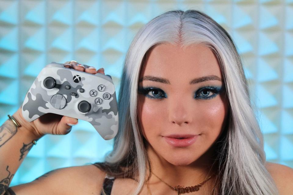 a woman holding a game controller