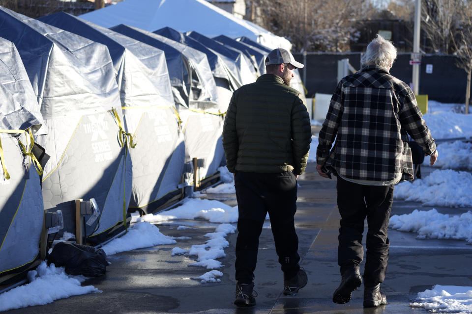 Tents stand in a long row at the east safe outdoor space in the parking lot of the city of Denver Human Service building in Denver on Thursday, Feb. 17, 2022. The safe space is home to more than 150 people. (AP Photo/David Zalubowski)