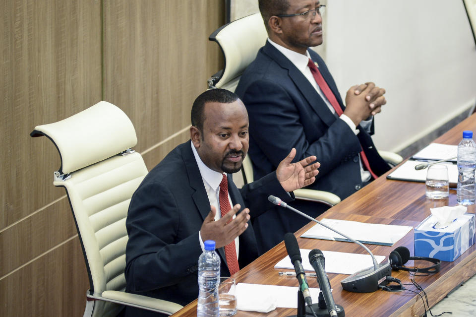 FILE - Ethiopia's Prime Minister Abiy Ahmed, left, accompanied by House speaker Tagesse Chafo, right, addresses the parliament in the capital Addis Ababa, Ethiopia on Nov. 15, 2022. In 2023 urgently needed grain and oil have disappeared again for millions caught in a standoff between Ethiopia's government, the United States and United Nations over what U.S. officials say may be the biggest theft of food aid on record. (AP Photo, File)