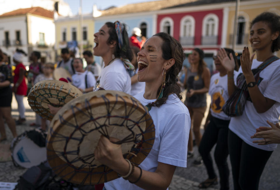 Protesters sing and play drums during a march against the Brazilian government's environmental policies, on the sidelines of a climate change meeting in Salvador, Brazil, Wednesday, Aug. 21, 2019. Environment Minister Salles was booed Wednesday as he took the stage at a five-day U.N. workshop on climate change in Salvador, an event he had tried to cancel earlier this year. (AP Photo/Victor R. Caivano)