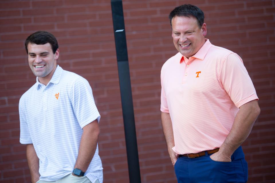 Current Tennessee quarterback Navy Shuler, left, and his dad and former Tennessee football great Heath Shuler, right, share a laugh at the Boys & Girls Club of the Tennessee Valley on Monday, Aug. 29, 2022. The father and son duo are bringing a reproduction of their jersey number 21 to Alumni Hall to support Boys & Girls Clubs of the Tennessee Valley.