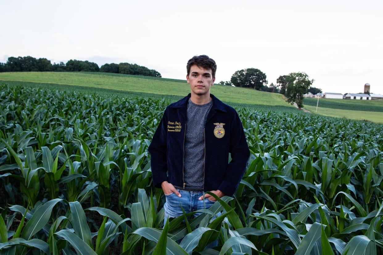 Connor Portz, outgoing Loudonville FFA President, poses in a cornfield onh=his family farm north of Loudonville.