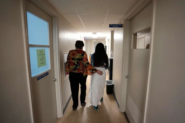 PHOTO: A 33-year-old mother of three from central Texas is escorted down the hall by clinic administrator Kathaleen Pittman prior to getting an abortion, Oct. 9, 2021, at Hope Medical Group for Women in Shreveport, La. (Rebecca Blackwell/AP, FILE)