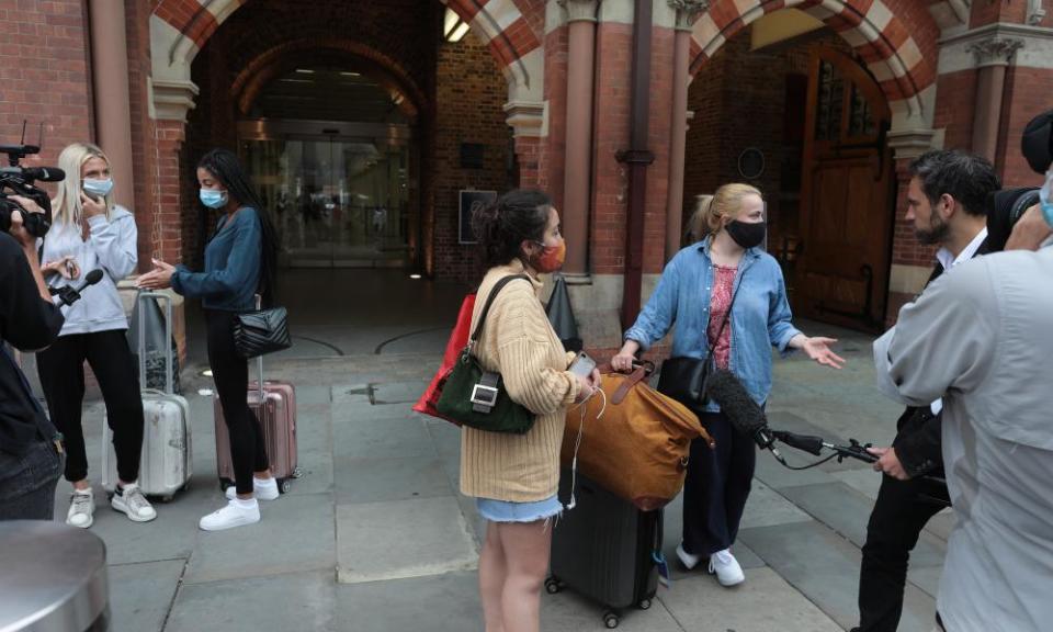 Reporters interview arriving passengers at St Pancras.