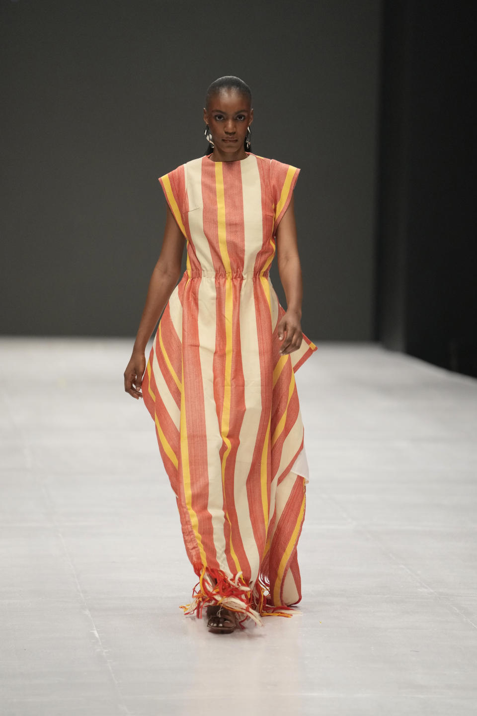 A model displays a creation by Cynthia Abila during the Lagos Fashion Week in Lagos, Nigeria, Thursday, Oct. 26, 2023. Africa's fashion industry is rapidly growing to meet local and international demands but a lack of adequate investment still limits its full potential, UNESCO said Thursday in its new report released at this year's Lagos Fashion Week show. (AP Photo/Sunday Alamba)