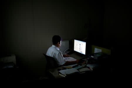 A North Korean defector, who declined to be named and requested his face not to be photographed due to his safety, looks at a screen as he poses for photographs after an interview with Reuters in Seoul, South Korea, September 26, 2016. REUTERS/Kim Hong-Ji