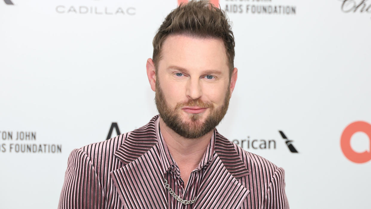  Bobby Berk at an event in a pinkish suit. 