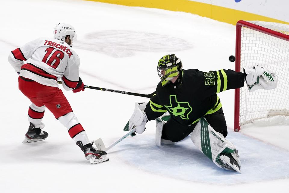 Carolina Hurricanes center Vincent Trocheck (16) scores against Dallas Stars' Jake Oettinger (29) during the shootout in an NHL hockey game in Dallas, Saturday, Feb. 13, 2021. The Hurricanes won 4-3. (AP Photo/Tony Gutierrez)