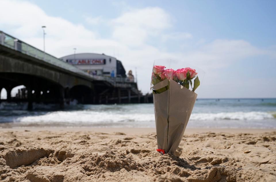 A bunch of flowers left on Bournemouth beach for a 17-year-old-boy and a girl aged 12 who sustained 