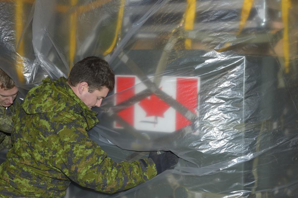 Members of the advance party of the Disaster Assistance Response Team (DART) loads a C177 Globemaster bound for Hawaii at Canadian Forces Base Trenton